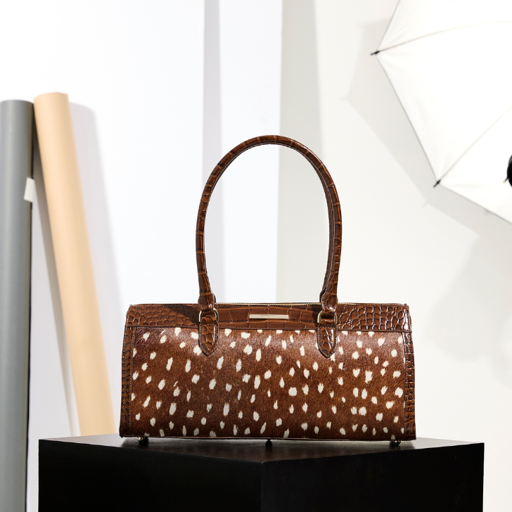 Brahmin Cinnamon Wilds Sophia top handle handbag in brown and cream spotted pattern with structured silhouette, double handles and glossy trim.